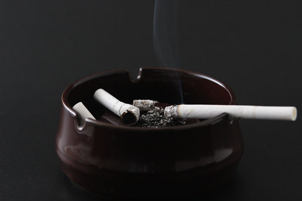 灰皿に置かれているタバコの画像